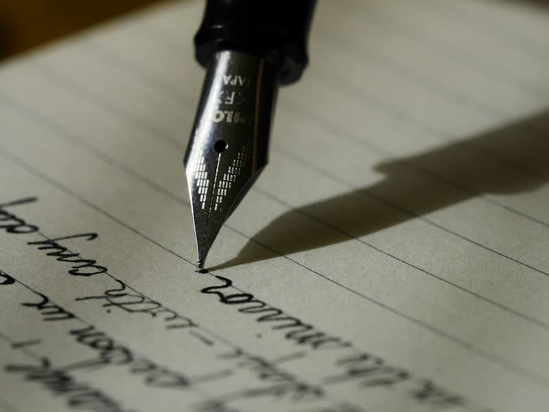 A person writing answers in a notebook